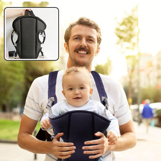 bebe et son papa sourient dans le porte bébé